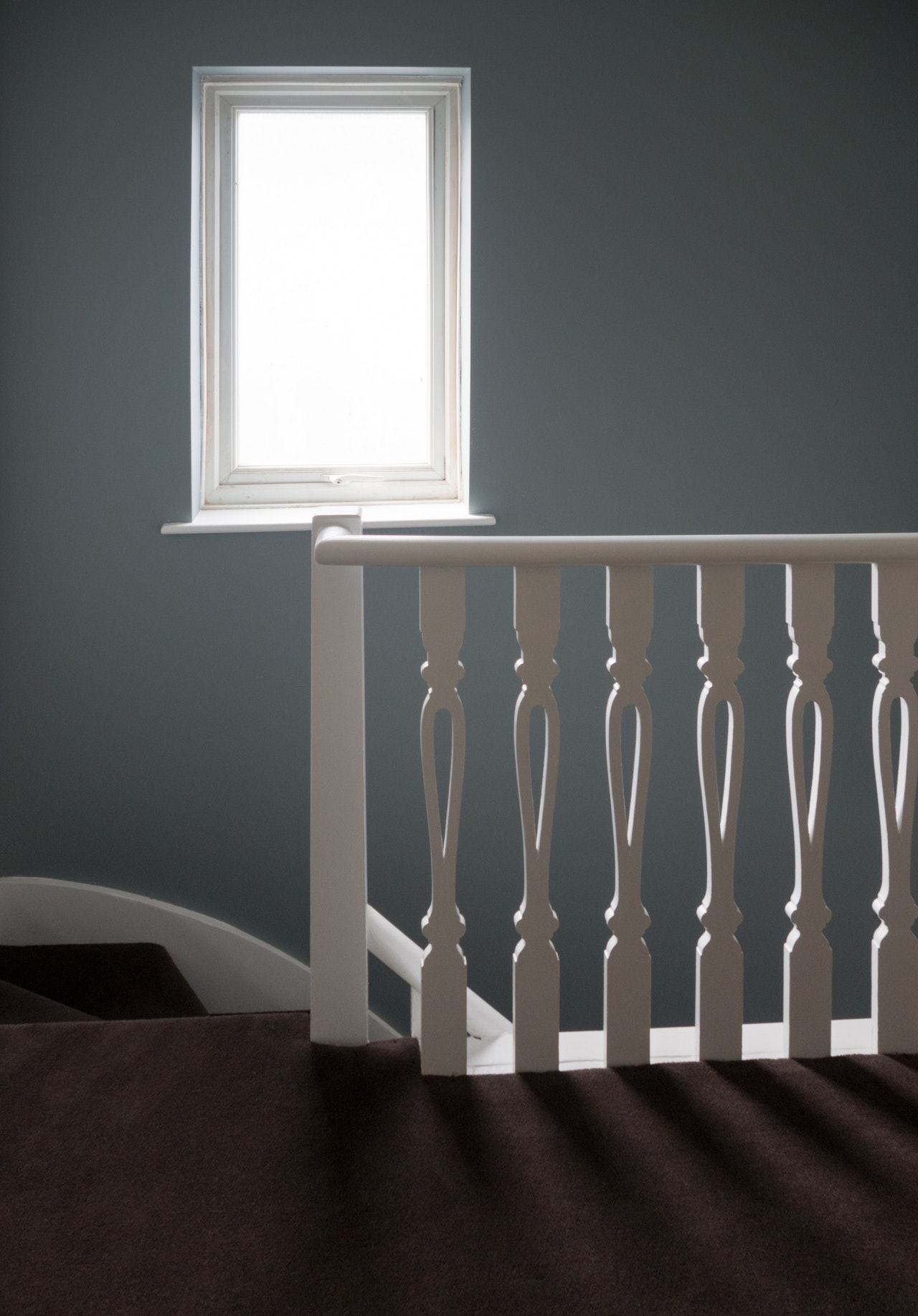 photo-of-white-window-frame-an-white-wooden-stair-balustrade-2885870